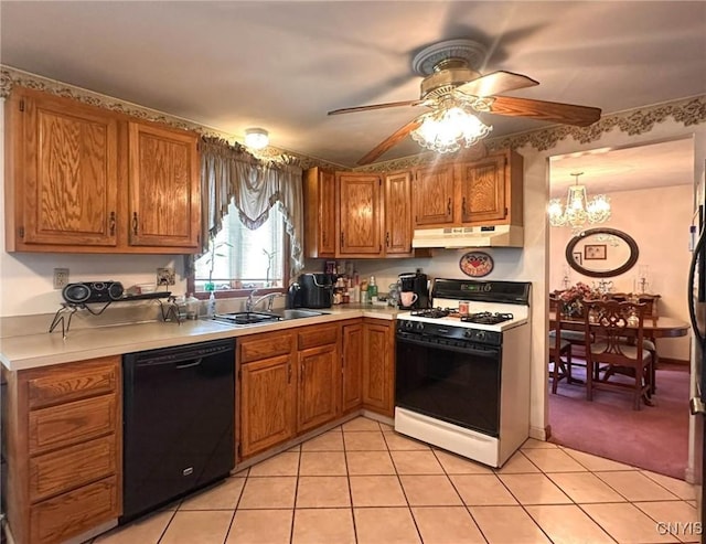 kitchen featuring a sink, gas range, dishwasher, light countertops, and under cabinet range hood