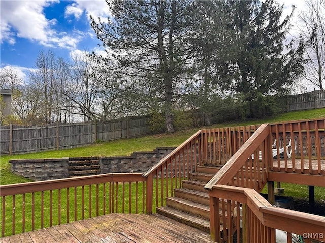 wooden deck featuring a lawn, a fenced backyard, and stairs