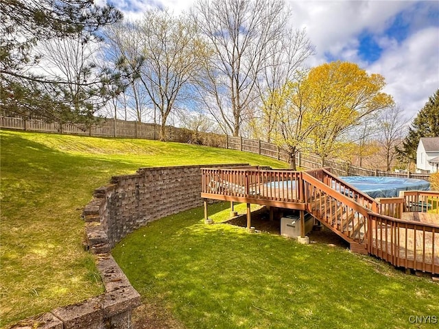 view of yard with a wooden deck, a fenced in pool, and a fenced backyard
