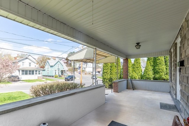 view of patio / terrace featuring a residential view and covered porch