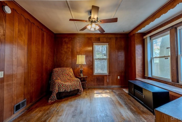 sitting room with ceiling fan, a healthy amount of sunlight, hardwood / wood-style floors, and visible vents