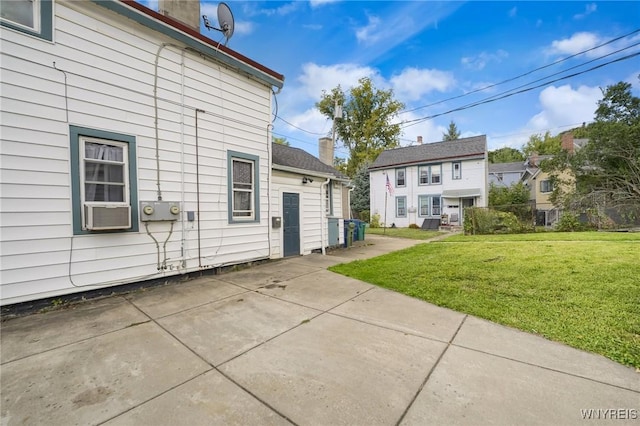 348 Virginia St, Buffalo, NY 14201 - rear view of house featuring a chimney, a yard, and a patio