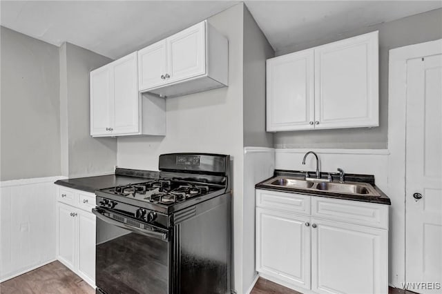 348 Virginia St, Buffalo, NY 14201 - kitchen featuring dark countertops, gas stove, a sink, and white cabinetry