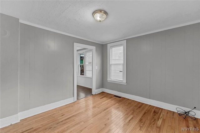 348 Virginia St, Buffalo, NY 14201 - empty room featuring light wood-type flooring, visible vents, baseboards, and ornamental molding