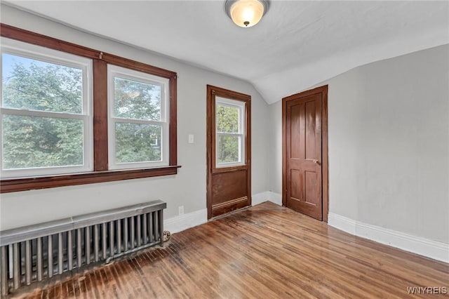 348 Virginia St, Buffalo, NY 14201 - entryway with radiator, vaulted ceiling, baseboards, and wood finished floors