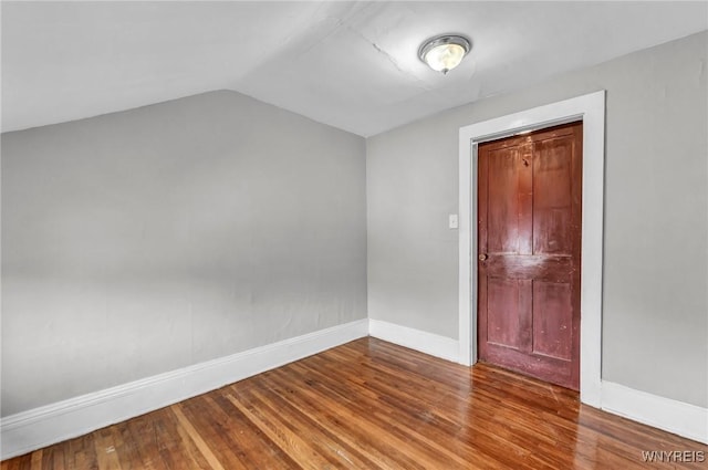 348 Virginia St, Buffalo, NY 14201 - empty room with lofted ceiling, wood finished floors, and baseboards