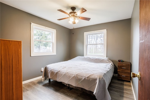 bedroom with baseboards, a ceiling fan, and wood finished floors