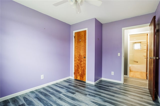 unfurnished bedroom featuring baseboards, ceiling fan, and dark wood finished floors