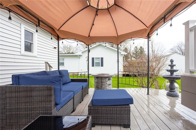 deck with a gazebo, a lawn, fence, and an outdoor living space