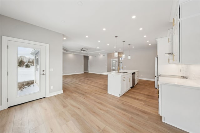 2 Stella Ln, Ogden, NY 14559 - kitchen with stainless steel appliances, white cabinets, light countertops, open floor plan, and light wood-style floors