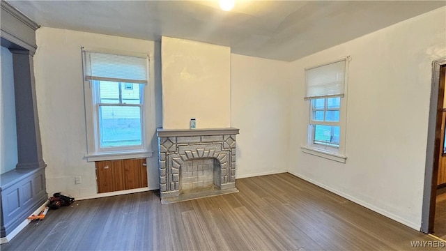 86 Roehrer Ave, Buffalo, NY 14208 - unfurnished living room featuring baseboards, wood finished floors, and a fireplace
