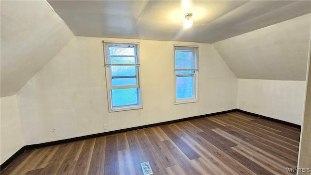 86 Roehrer Ave, Buffalo, NY 14208 - additional living space with vaulted ceiling, visible vents, baseboards, and wood finished floors