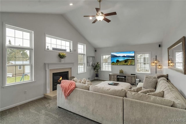living room featuring high vaulted ceiling, a glass covered fireplace, ceiling fan, baseboards, and carpet flooring