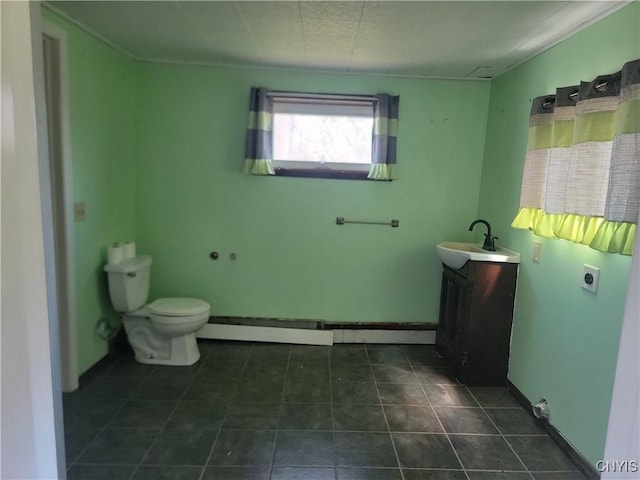 bathroom with toilet, vanity, and tile patterned floors