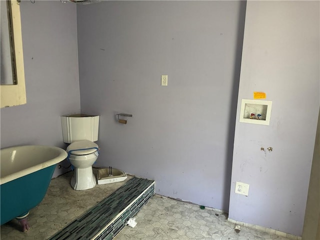 bathroom with a freestanding bath and toilet