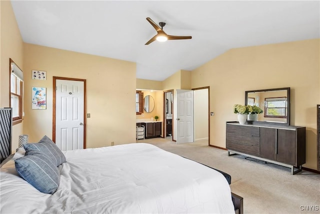 bedroom featuring light colored carpet, lofted ceiling, a ceiling fan, and baseboards