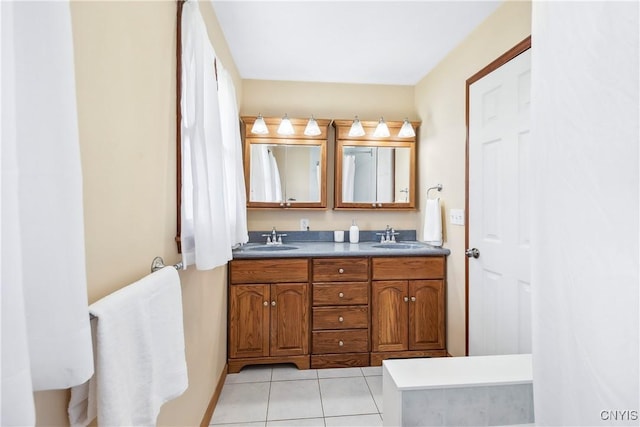 bathroom featuring double vanity, tile patterned flooring, and a sink