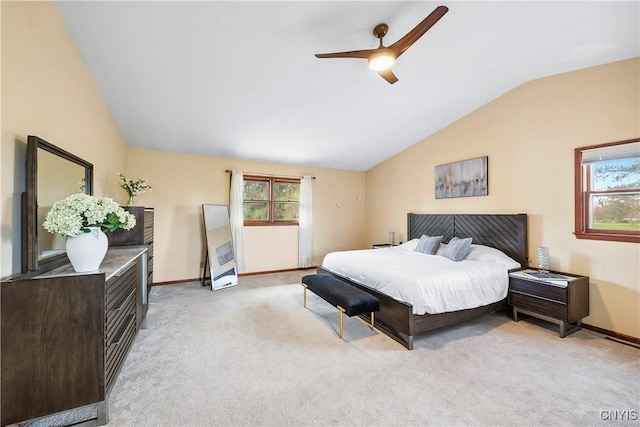 bedroom featuring light colored carpet, vaulted ceiling, a ceiling fan, and baseboards
