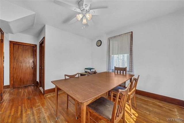 dining space with hardwood / wood-style flooring, a ceiling fan, and baseboards