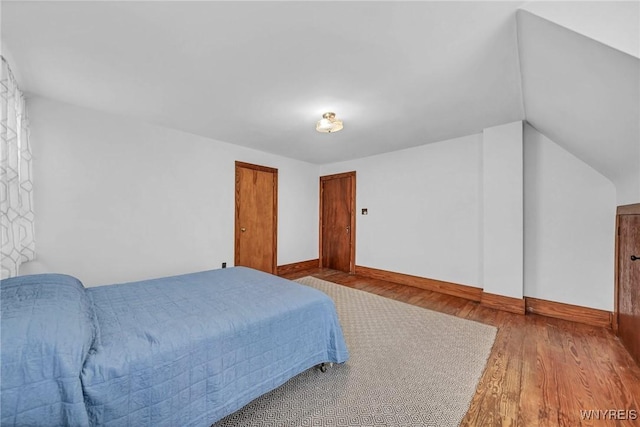 bedroom with baseboards and wood finished floors