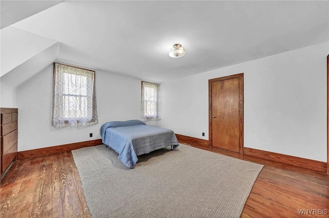 bedroom featuring baseboards and wood finished floors