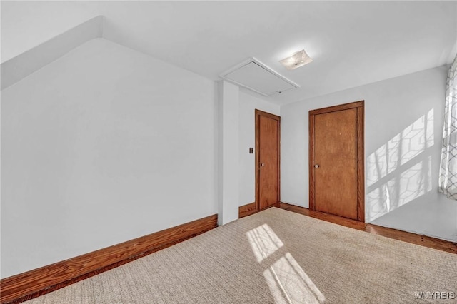 bonus room featuring attic access and carpet