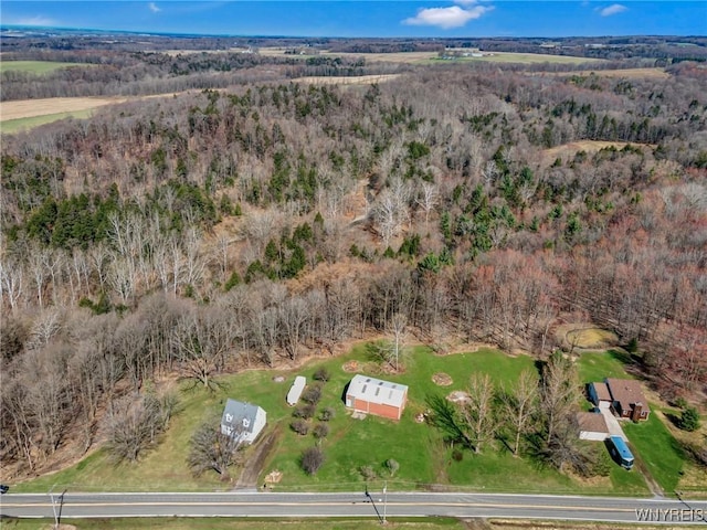 birds eye view of property featuring a view of trees