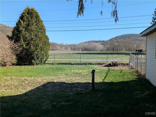 view of yard featuring fence and a rural view