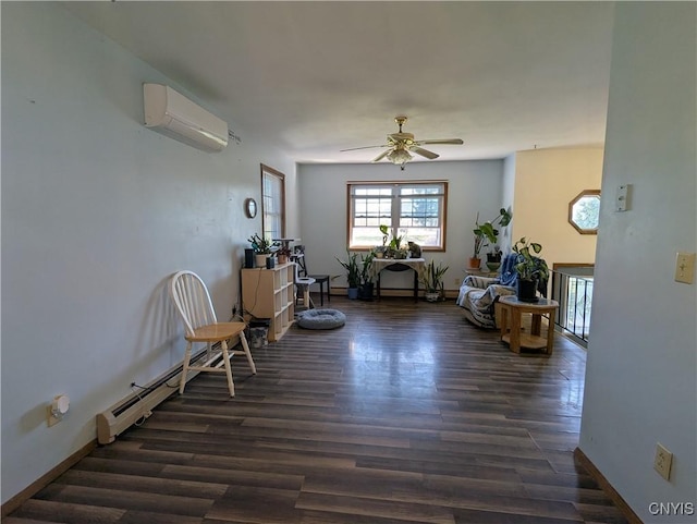 living area with a wall mounted air conditioner, baseboards, a ceiling fan, and wood finished floors