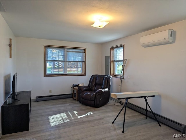 sitting room featuring a baseboard radiator, wood finished floors, an AC wall unit, and a baseboard heating unit