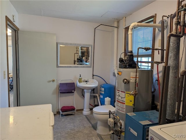 bathroom with gas water heater and toilet