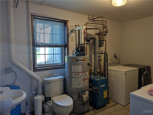 interior space with a sink, a heating unit, washing machine and dryer, water heater, and laundry area