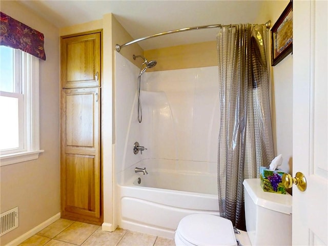 full bath with tile patterned floors, toilet, baseboards, visible vents, and shower / tub combo