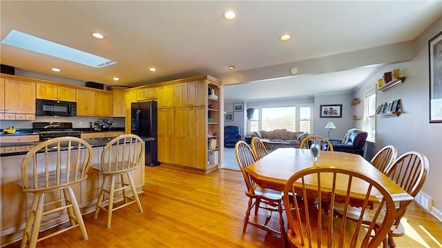 dining room with recessed lighting, light wood-style floors, visible vents, and a skylight