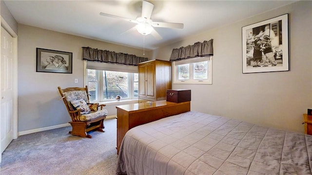 carpeted bedroom featuring baseboards, a ceiling fan, and multiple windows