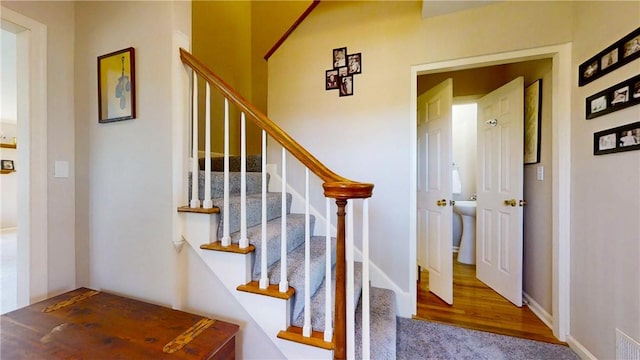stairway featuring wood finished floors