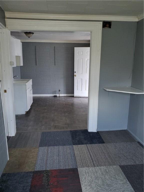 interior space with dark floors and baseboards