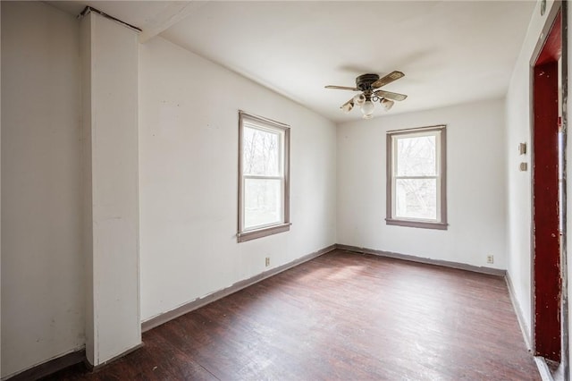 spare room featuring baseboards, a ceiling fan, and wood finished floors