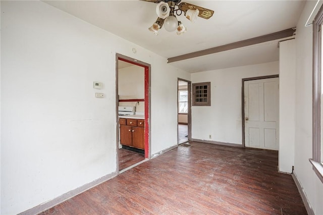 empty room with beamed ceiling, wood finished floors, baseboards, and ceiling fan