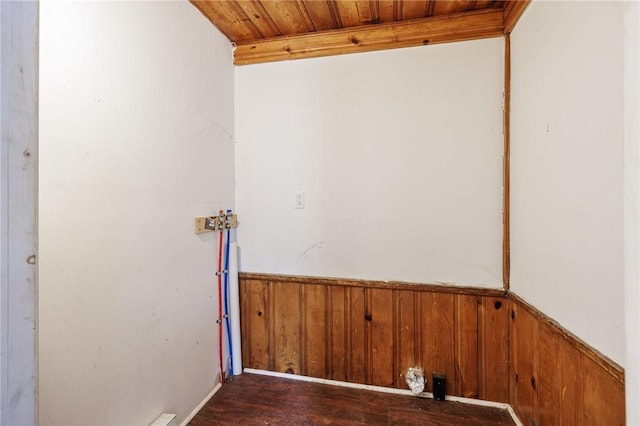clothes washing area featuring laundry area, wooden walls, wooden ceiling, wainscoting, and washer hookup