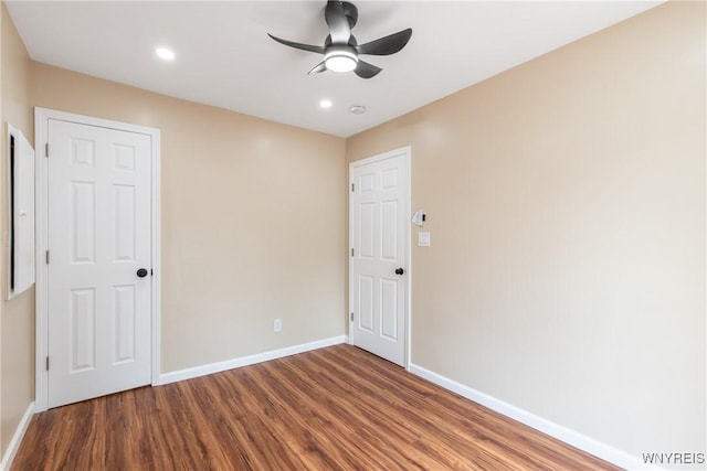unfurnished room featuring recessed lighting, wood finished floors, baseboards, and ceiling fan