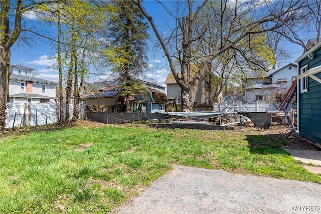 view of yard featuring fence and a residential view