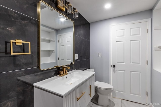 bathroom featuring toilet and vanity