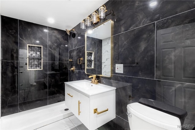 full bath with a shower stall, tile walls, toilet, and vanity
