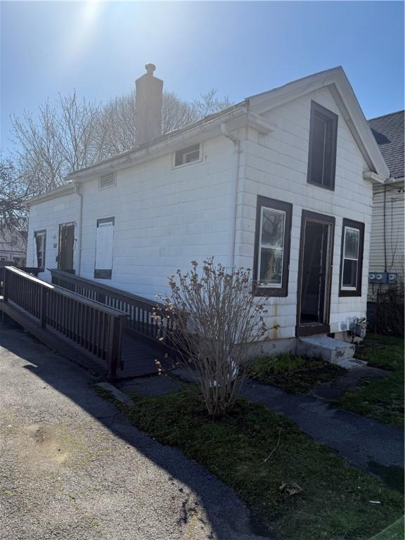 view of front of house with a wooden deck and a chimney