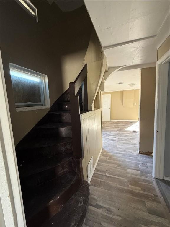 stairs featuring wood finished floors and visible vents