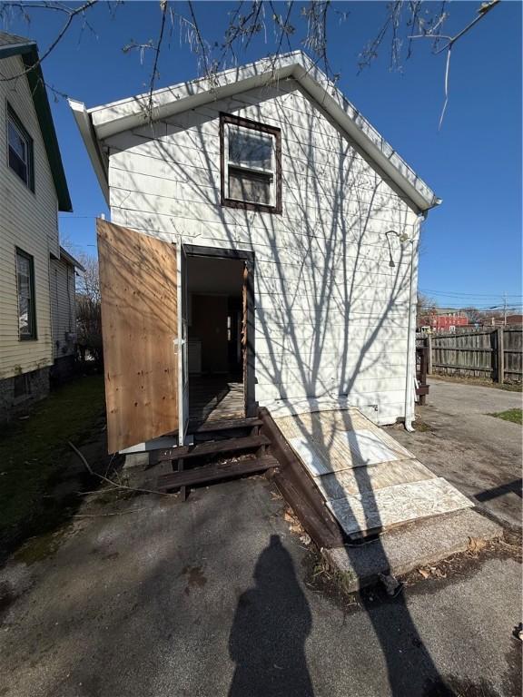 view of outbuilding featuring fence