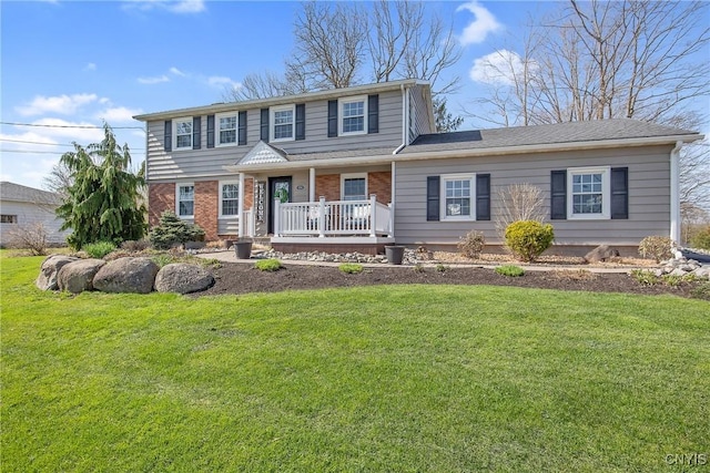 traditional home with brick siding, a front lawn, and covered porch