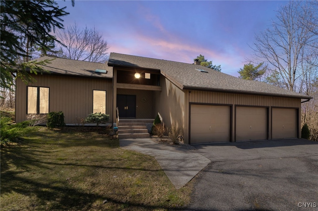 5299 Burke Ln, Dewitt, NY 13066 - view of front of house with a chimney, an attached garage, driveway, and a shingled roof