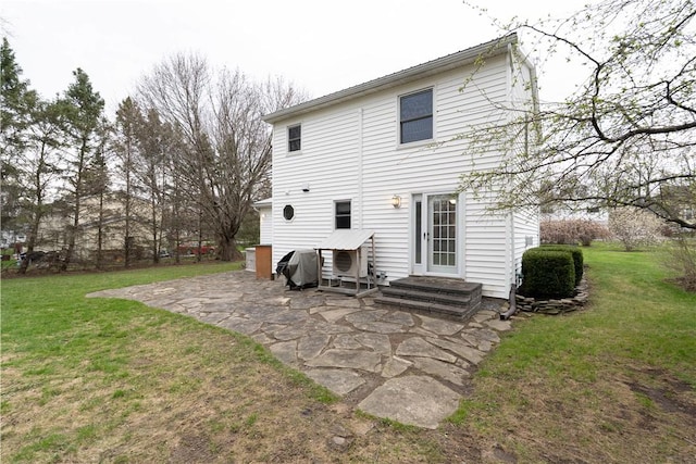 rear view of house with a yard and a patio